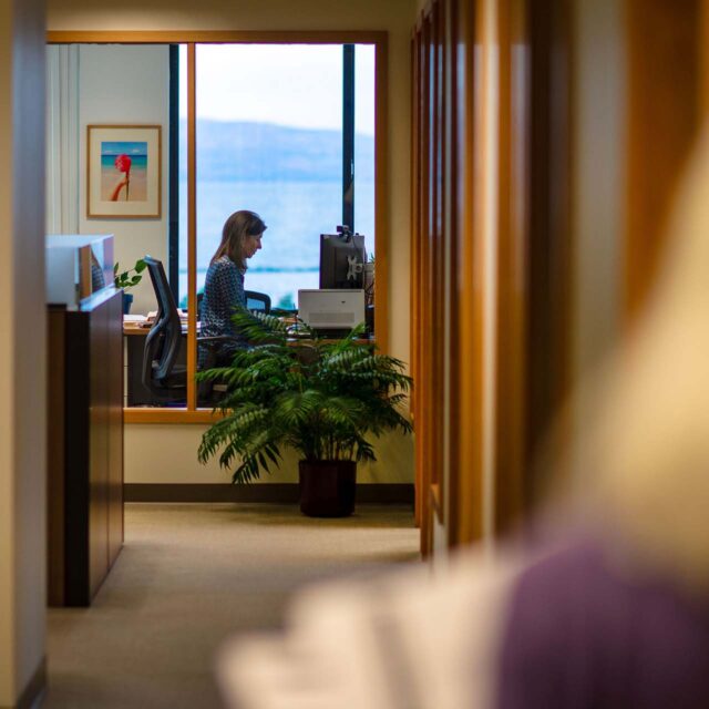 attorney sitting at desk working on a computer