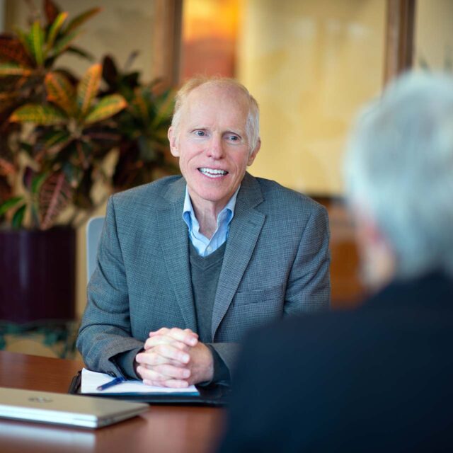 Sheehey attorney smiling at table during meeting