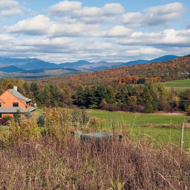 landscape of a brown home with hills and mountains in background