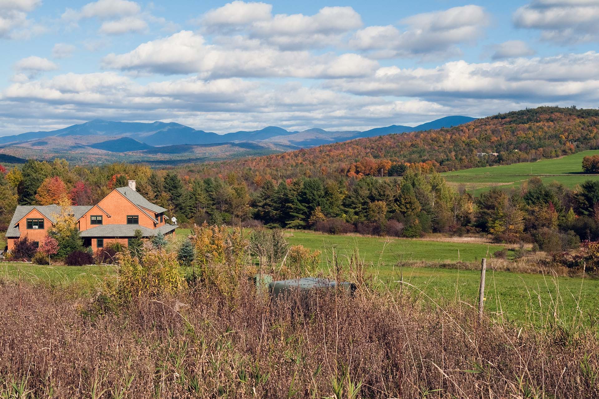 landscape of a brown home with hills and mountains in background