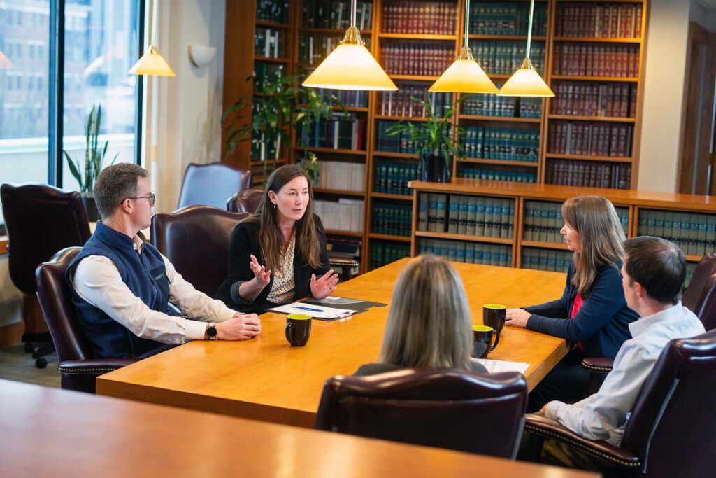 SF&B Attorneys talking at table during a meeting in a conference room